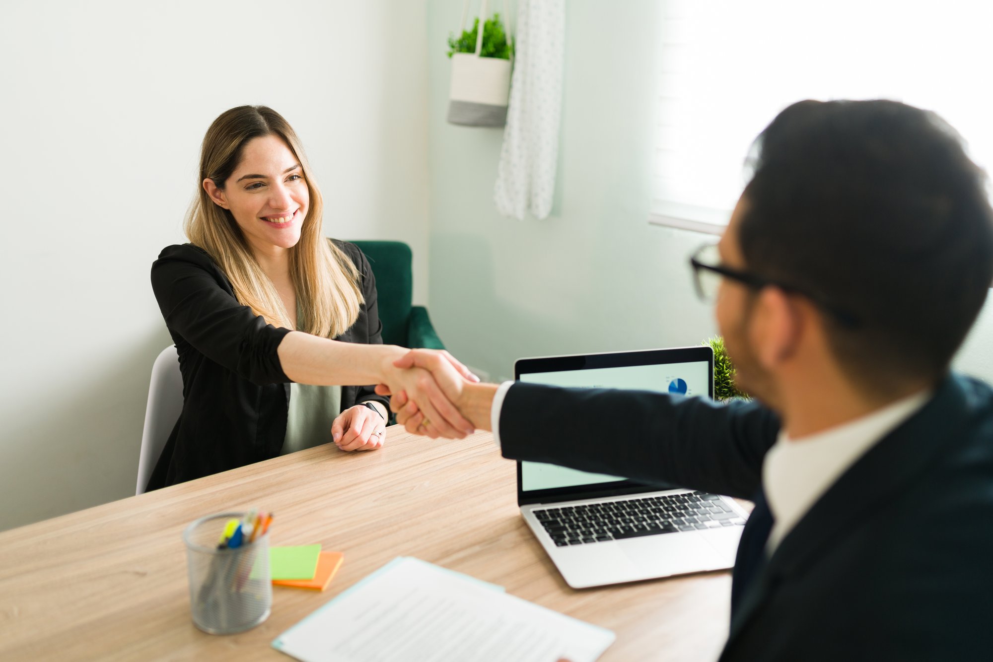 happy-caucasian-woman-shaking-hands-with-latin-man-business-meeting-with-lawyer-manager-hiring-beautiful-professional-woman-new-job